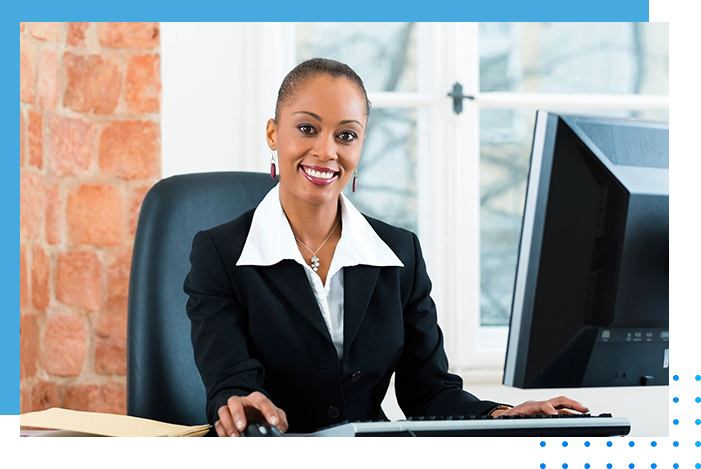 A woman sitting at her desk in front of a computer.