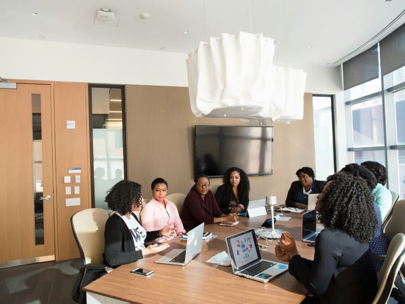 A group of people sitting around a table.